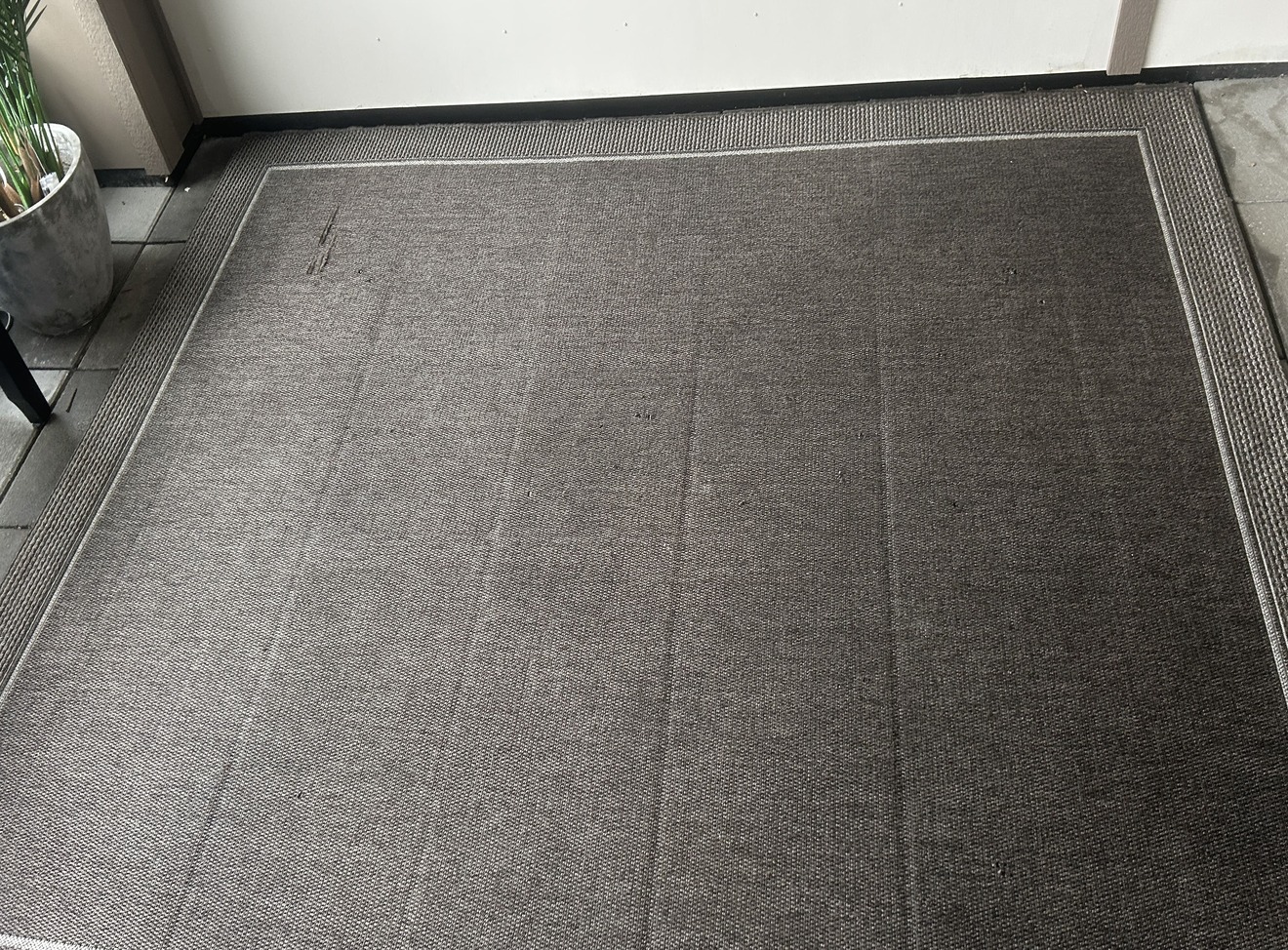 Dark carpet with visible traffic lane before professional cleaning in Kelowna