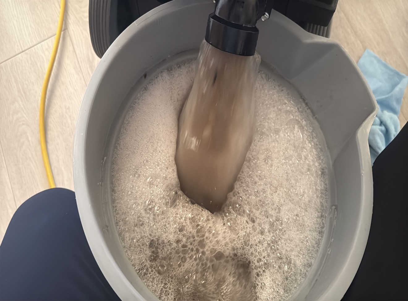 Dark brown waste water in extractor tank after cleaning viscose rug in Kelowna