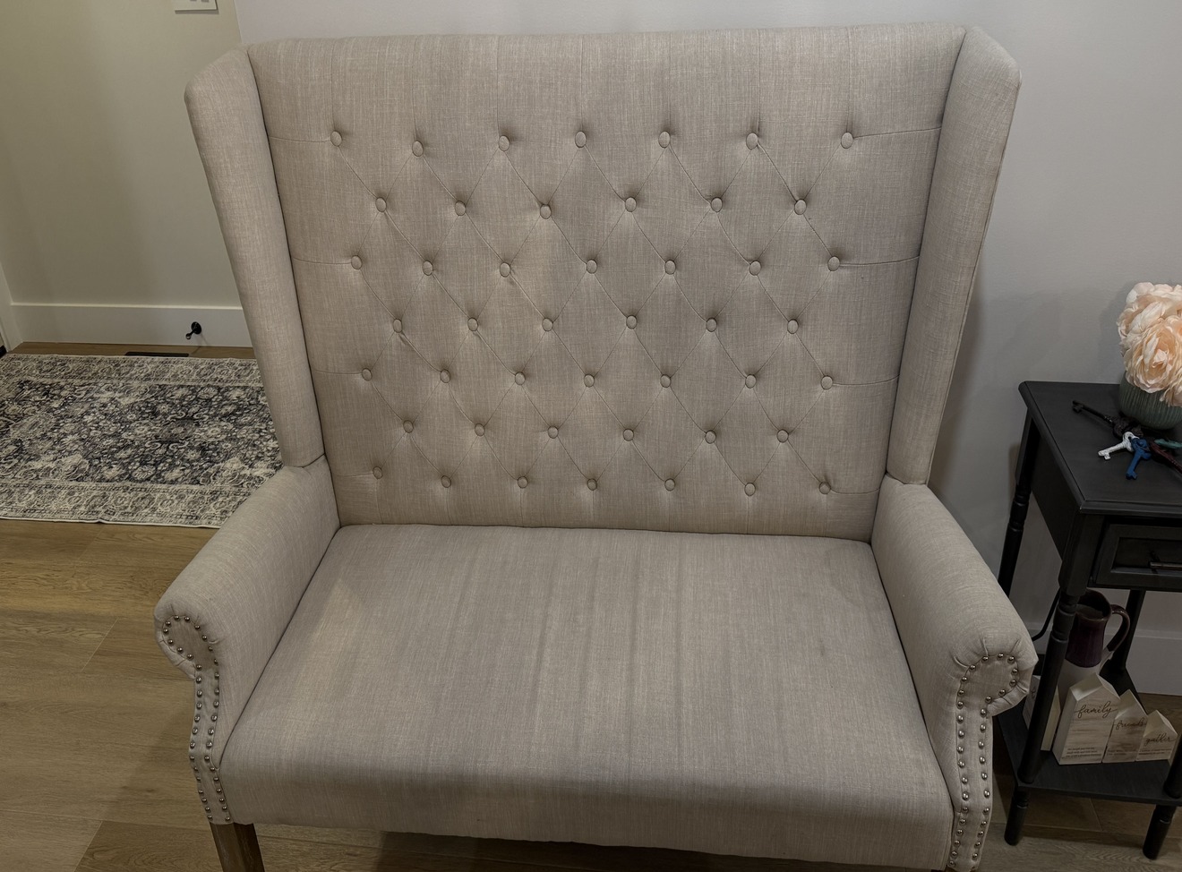 Loveseat seat cushion before cleaning - heavy soiling visible, fabric noticeably darker than surrounding upholstery