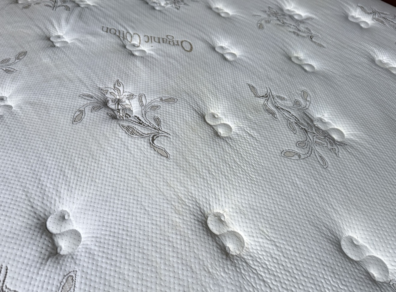 Queen-size mattress with urine stains before professional cleaning in Kelowna