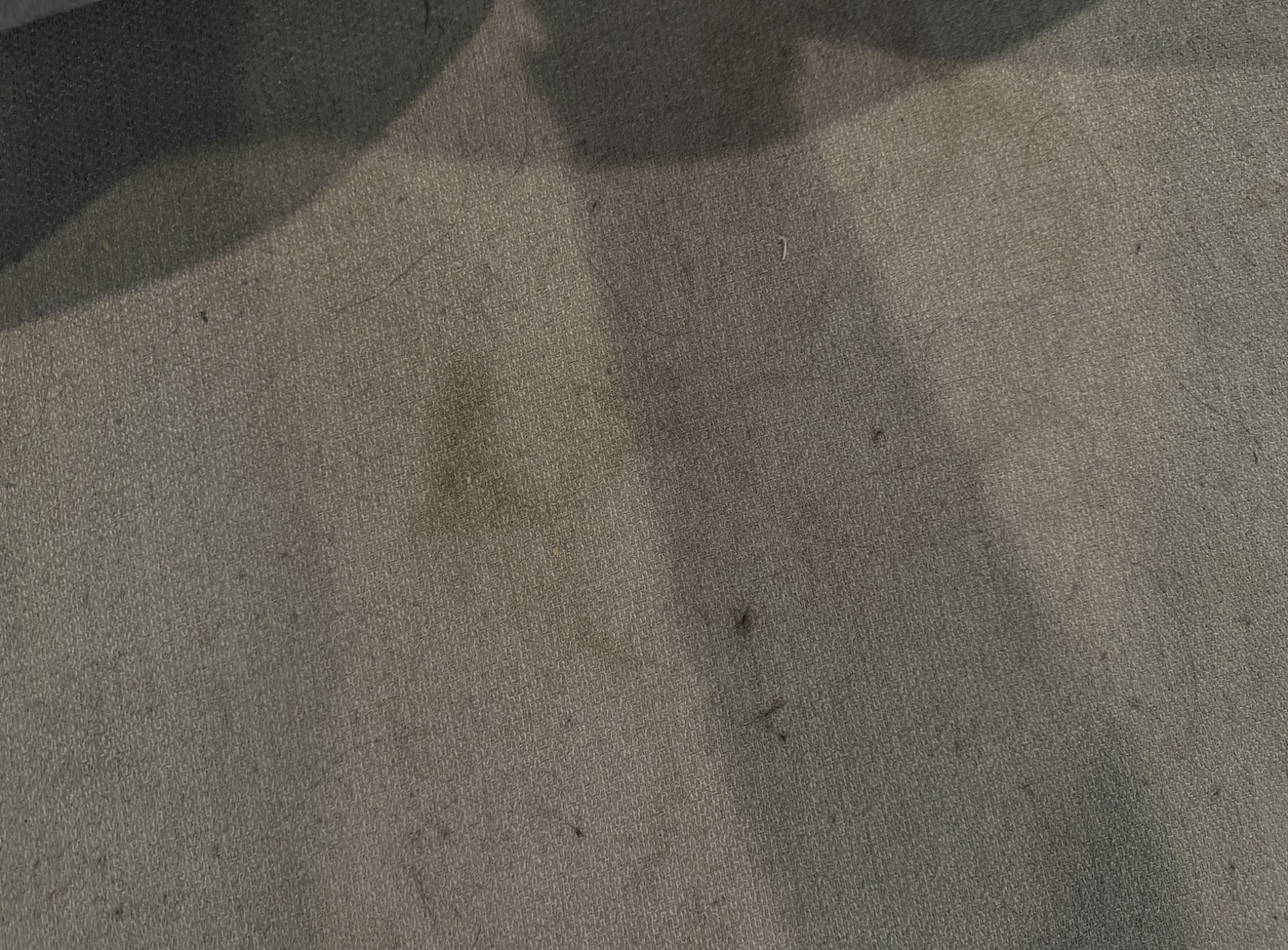 Close-up of heavily soiled sofa fabric before professional cleaning in Kelowna, showing general soiling and staining throughout