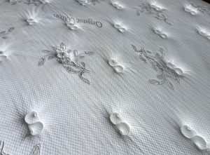 Queen-size mattress with urine stains before professional cleaning in Kelowna