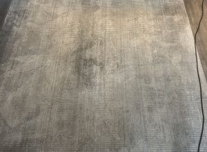 Synthetic rug with dull, soiled fibres before hot water extraction cleaning in Kelowna
